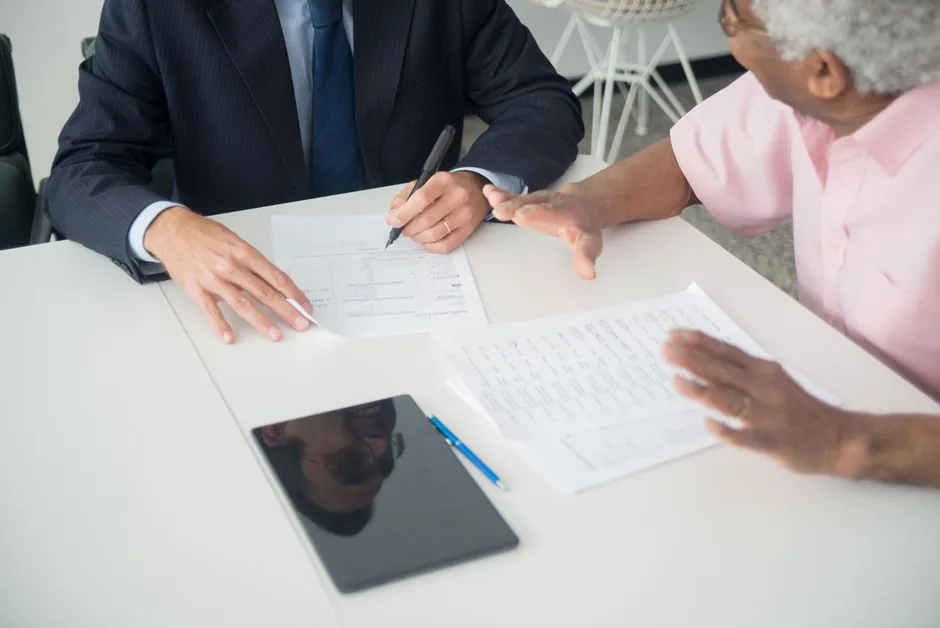 Client and consultant reviewing documents across an office table — vendor selection guide for brands choosing AI consulting firms