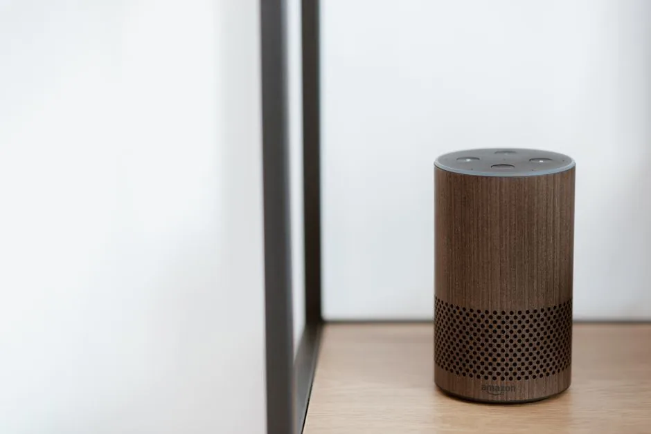 Illustration showing a user speaking to a smart speaker while a brand’s AI consulting team maps natural‑language voice queries to product answers for better SEO.