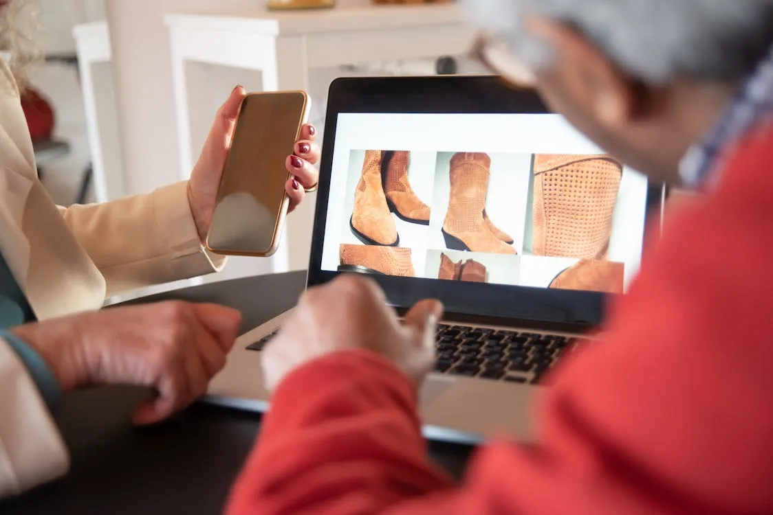 Two ecommerce managers reviewing AI-powered online store design on laptop — conversion optimization strategy for brands