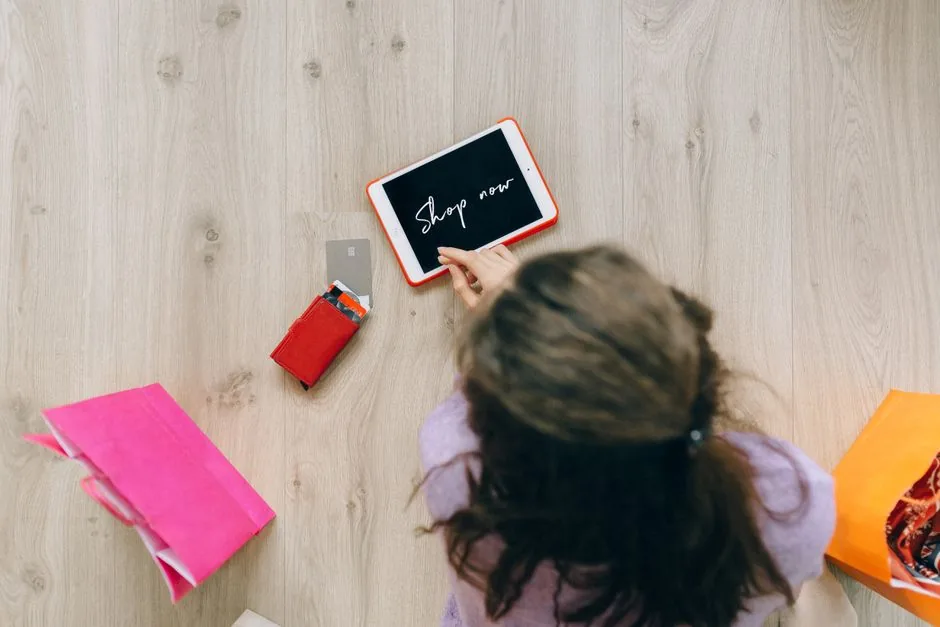 A retail marketer analyzing AI shopping data on a tablet to optimize their agentic commerce strategy for online shoppers.