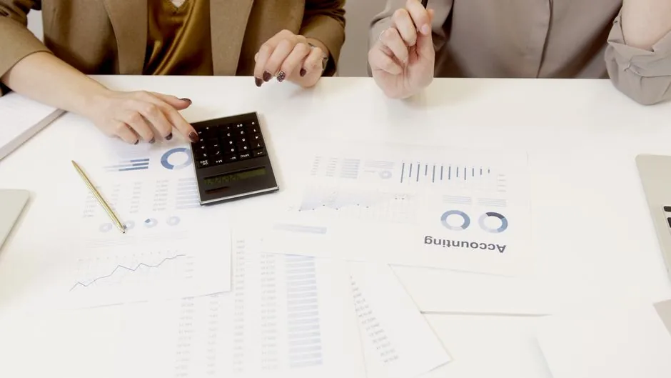 An accountant analyzing automated financial reports on a tablet to optimize business cash flow for e-commerce brands.