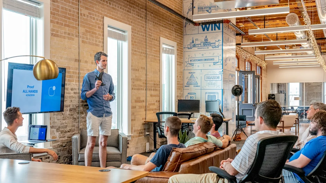 Brand team reviewing options around a laptop — decision guide for choosing an Amazon agency in 2026