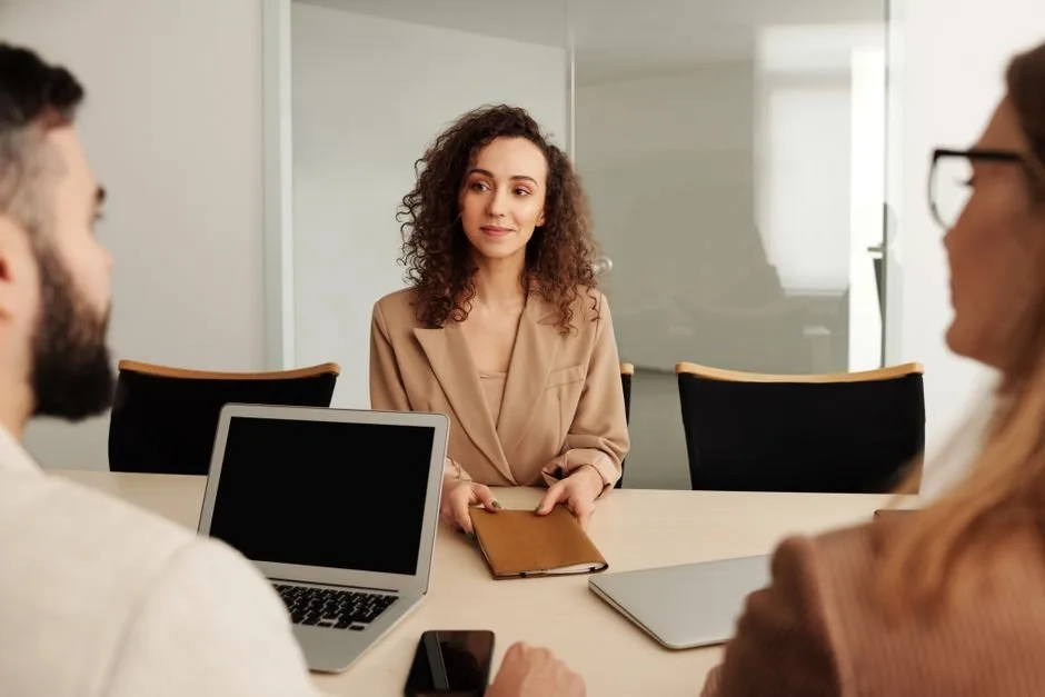 An HR professional reviewing resumes of Amazon brand manager candidates to build a modern, AI-driven e-commerce team.