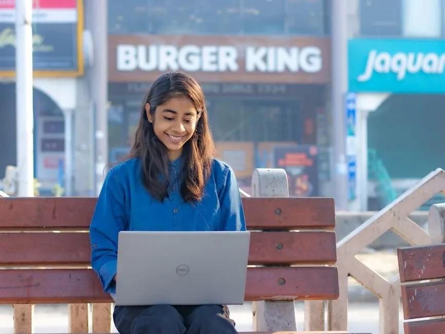 A remote Amazon brand manager analyzing sales data on a laptop to optimize product listings for e-commerce brands.