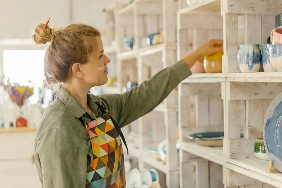 An artisan entrepreneur analyzing sales metrics on Amazon Seller Central Handmade to scale their handcrafted brand.