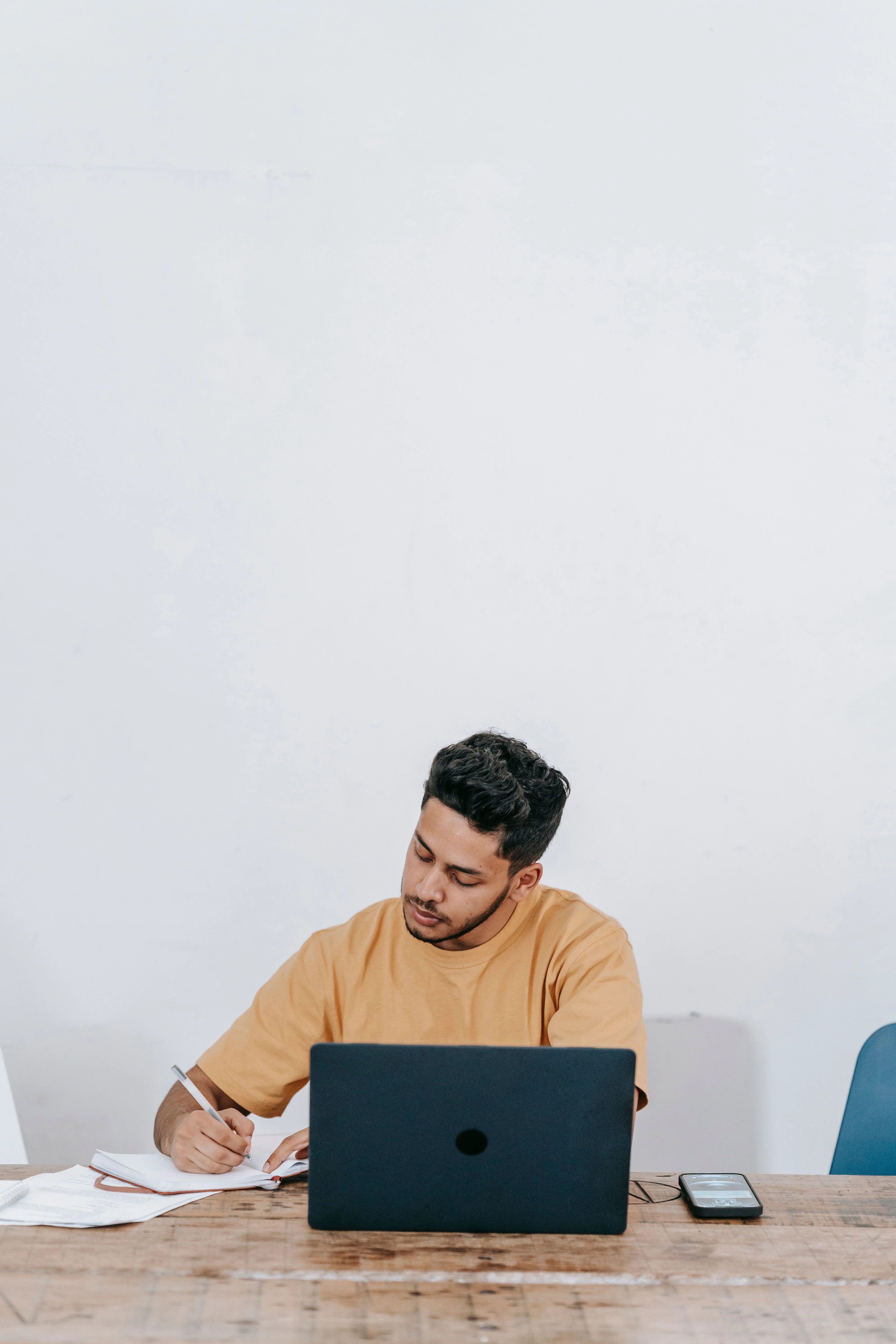 Remote worker taking notes with a laptop — searching for Amazon Seller Central jobs near me and remote roles